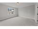 Well-lit bedroom with carpeting and neighborhood view at 2404 Toll Mill Ct, Raleigh, NC 27606