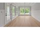 Light-filled dining room with hardwood floors and access to a screened porch at 2404 Toll Mill Ct, Raleigh, NC 27606