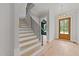 Bright and spacious entryway with hardwood floors and elegant staircase at 2404 Toll Mill Ct, Raleigh, NC 27606