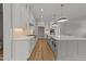 Open concept kitchen with white cabinets, a large island, and a breakfast area at 2404 Toll Mill Ct, Raleigh, NC 27606