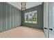 Home office with green walls, wood floors, and a large window at 2404 Toll Mill Ct, Raleigh, NC 27606