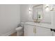 Modern powder room with white vanity, gold fixtures, and marble countertop at 2404 Toll Mill Ct, Raleigh, NC 27606
