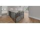 Upstairs hallway with hardwood floors and a view of a bedroom at 2404 Toll Mill Ct, Raleigh, NC 27606