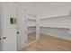Large walk-in closet with ample shelving and hanging space at 2404 Toll Mill Ct, Raleigh, NC 27606