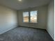 Bright bedroom with carpet flooring and two windows at 257 Magnolia Run Way, Benson, NC 27504