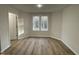 Bright bedroom with two windows and wood-look flooring at 257 Magnolia Run Way, Benson, NC 27504