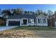 One-story house with gray siding, black shutters, and a two-car garage at 257 Magnolia Run Way, Benson, NC 27504