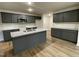 Modern kitchen with dark gray cabinets, granite countertops, and an island at 257 Magnolia Run Way, Benson, NC 27504
