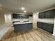 Modern kitchen with dark gray cabinets and granite countertops at 257 Magnolia Run Way, Benson, NC 27504