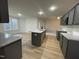 Open kitchen with island, granite countertops, and gray cabinets at 257 Magnolia Run Way, Benson, NC 27504