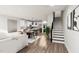 Open concept living space with modern kitchen, dining area, hardwood floors, and staircase at 3019 White Rail Dr, Fuquay Varina, NC 27526