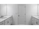 Bathroom featuring double sinks with a large mirror, white cabinets, and quartz countertops at 8703 Wardle Ct, Wake Forest, NC 27587