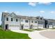 New townhomes featuring unique color schemes, attached garages and manicured lawns at 8703 Wardle Ct, Wake Forest, NC 27587