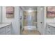 Bathroom featuring a tiled glass shower, double vanity, and neutral paint color at 8714 Wardle Ct, Wake Forest, NC 27587