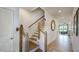 Bright hallway with natural light and wood flooring leading to a staircase with wooden banister at 8714 Wardle Ct, Wake Forest, NC 27587