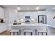 Modern kitchen with white cabinets, stainless steel appliances, and a large center island at 8716 Wardle Ct, Wake Forest, NC 27587