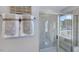 Modern tiled shower with glass enclosure and neutral-toned accents presents a luxurious bathroom at 8716 Wardle Ct, Wake Forest, NC 27587