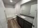 Bathroom with tub, toilet and dark vanity at 90 Faucette Dr, Selma, NC 27576