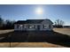 Newly constructed home with a gray exterior, landscaped yard, and driveway at 90 Faucette Dr, Selma, NC 27576