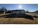 Newly constructed home with a gray exterior, landscaped yard, and driveway at 90 Faucette Dr, Selma, NC 27576