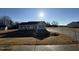 Newly constructed home with a gray exterior, landscaped yard, and driveway at 90 Faucette Dr, Selma, NC 27576