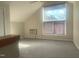 Attic space with ceiling fan, and window has a view of blue sky and trees at 943 St Marys St # B, Raleigh, NC 27605