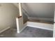 This attic has neutral-colored walls, grey carpeting, and built-in wood accents at 943 St Marys St # B, Raleigh, NC 27605