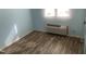 Cozy bedroom features laminate flooring and an air conditioning unit, offering comfort and practicality at 943 St Marys St # B, Raleigh, NC 27605