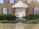 Close up view of entry to a brick building featuring white doors and a small white portico above at 943 St Marys St # B, Raleigh, NC 27605