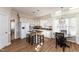 Eat-in kitchen with island, white cabinets, and hardwood floors at 1001 Chimney Hill Dr, Apex, NC 27502