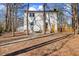 White house exterior with stone patio and walkway, surrounded by trees at 1013 Castalia Dr, Cary, NC 27513