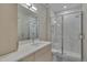 Modern bathroom with a large walk-in shower and marble tile at 1016 Manor Way, Durham, NC 27701