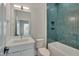 Modern bathroom with teal tile, white vanity, and bathtub at 1016 Manor Way, Durham, NC 27701