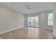 Bright bedroom with hardwood floors and sliding glass doors to deck at 1016 Manor Way, Durham, NC 27701