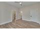 Spacious bedroom with hardwood floors and access to a bathroom and stairs at 1016 Manor Way, Durham, NC 27701