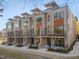 Modern townhouses with brick and metal siding, balconies, and private entrances at 1016 Manor Way, Durham, NC 27701
