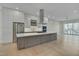 Modern kitchen with large island, stainless steel appliances, and white cabinets at 1016 Manor Way, Durham, NC 27701
