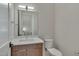 Modern bathroom with wood vanity and white toilet at 1018 Manor Way, Durham, NC 27701