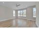 Bright bedroom with hardwood floors and large windows offering ample natural light at 1018 Manor Way, Durham, NC 27701