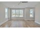 Spacious bedroom featuring hardwood floors and multiple windows at 1018 Manor Way, Durham, NC 27701