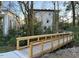 Wooden footbridge with metal railings providing access to the community at 1018 Manor Way, Durham, NC 27701