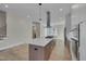 Open kitchen with island, stainless steel appliances, hardwood floors at 1018 Manor Way, Durham, NC 27701