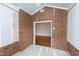 Bright sunroom with brick walls and tiled floors at 1019 Thistle Briar Pl, Cary, NC 27511