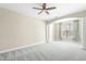Open bedroom area featuring a ceiling fan, neutral tones, and bright natural light at 10511 Sablewood Dr # 110, Raleigh, NC 27617