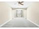 Open bedroom area featuring a ceiling fan, neutral tones, and bright natural light at 10511 Sablewood Dr # 110, Raleigh, NC 27617