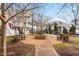 Community courtyard featuring benches around a stone fire pit and lush landscaping at 10511 Sablewood Dr # 110, Raleigh, NC 27617
