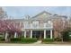 Inviting townhome with brick facade, balcony, and spring blossoms at 10511 Sablewood Dr # 110, Raleigh, NC 27617