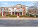 Beautiful townhome with brick facade, private balcony, and manicured landscaping at 10511 Sablewood Dr # 110, Raleigh, NC 27617