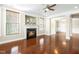 Open living space featuring a fireplace, hardwood floors, and plenty of natural light from large windows at 10511 Sablewood Dr # 110, Raleigh, NC 27617