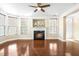 Bright living room with a cozy fireplace, hardwood floors, and natural light streaming through the windows at 10511 Sablewood Dr # 110, Raleigh, NC 27617